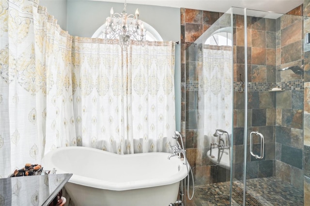 bathroom with independent shower and bath and an inviting chandelier