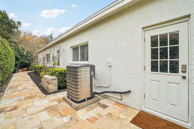 exterior space featuring a patio area and cooling unit