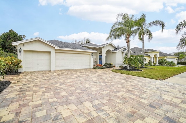 single story home featuring a garage and a front yard