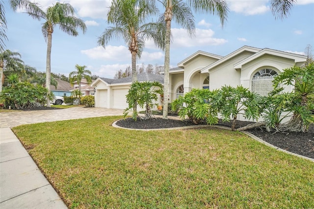 view of front of property featuring a garage and a front lawn