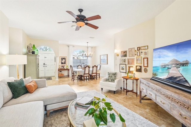 living room with ceiling fan with notable chandelier and light tile patterned flooring