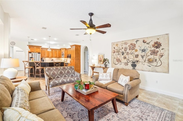 living room featuring light tile patterned flooring and ceiling fan