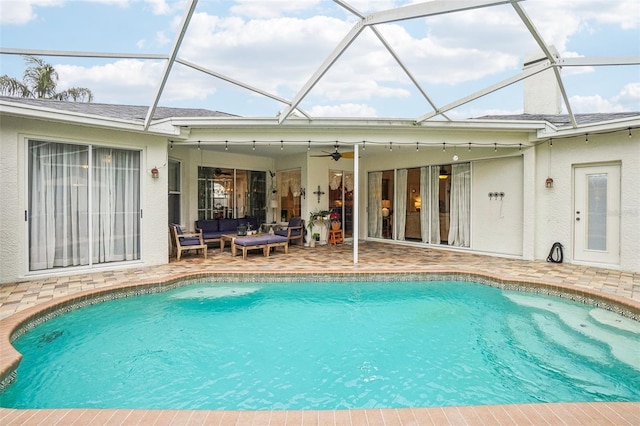 view of pool featuring an outdoor living space, ceiling fan, a patio, and a lanai