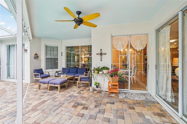 sunroom featuring ceiling fan