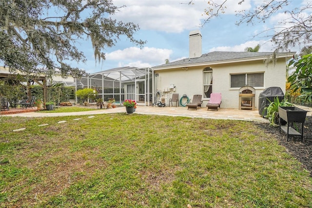 back of house with a patio and a lawn