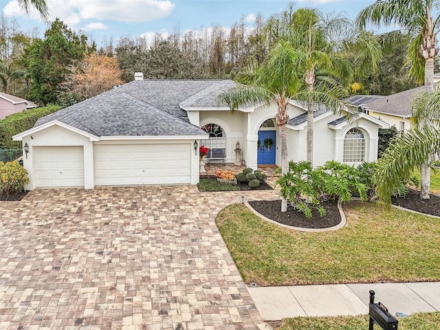 view of front of home featuring a front yard and a garage