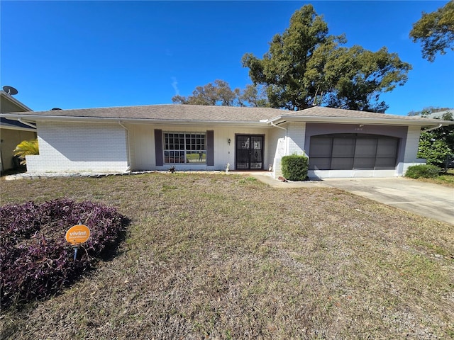 ranch-style house with a garage and a front lawn