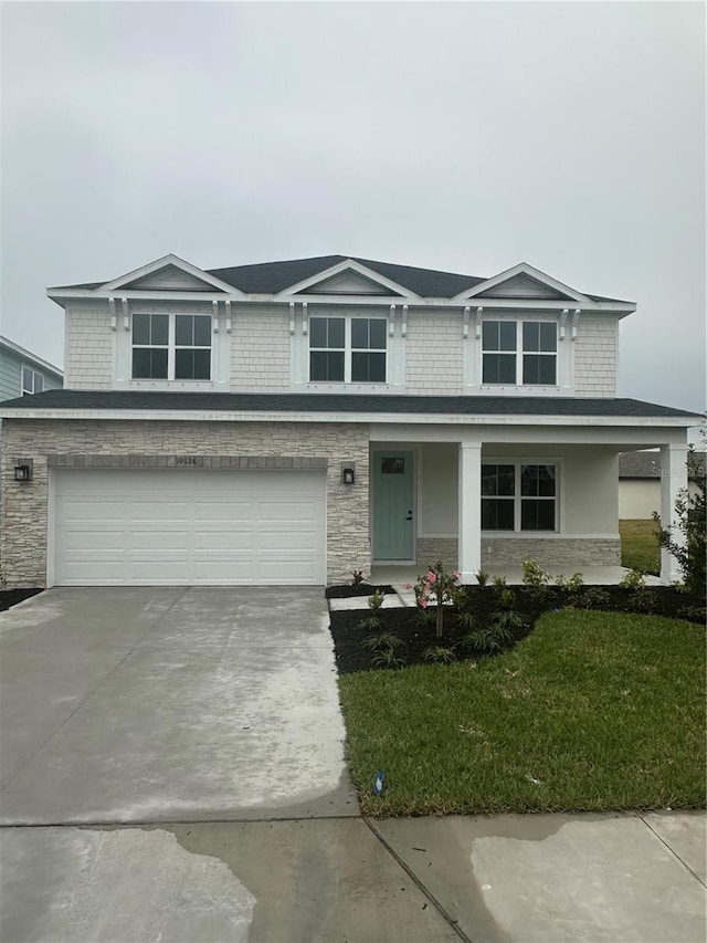 view of front of home featuring a garage and a front lawn