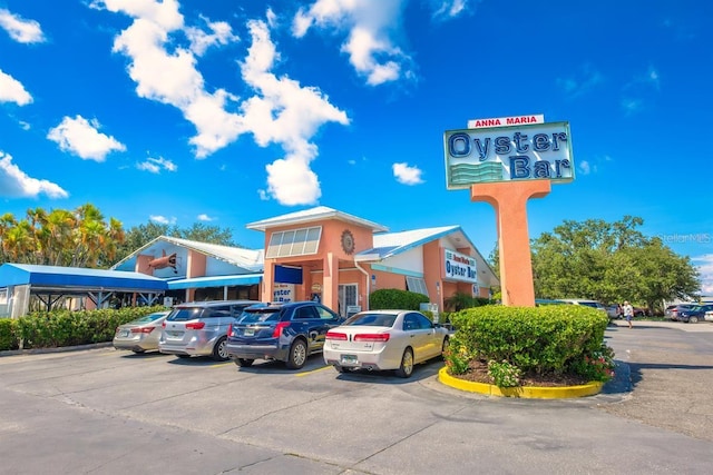 view of building exterior with uncovered parking