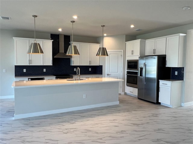 kitchen with marble finish floor, wall chimney exhaust hood, appliances with stainless steel finishes, and a sink