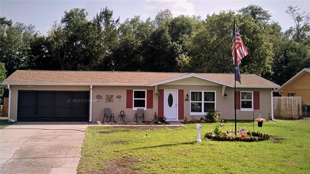 ranch-style home featuring a garage and a front yard