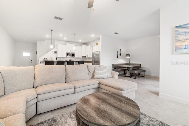 tiled living room featuring ceiling fan