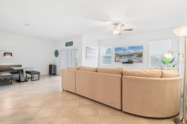 tiled living room featuring ceiling fan