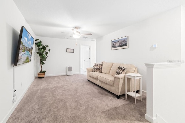 carpeted living room with ceiling fan