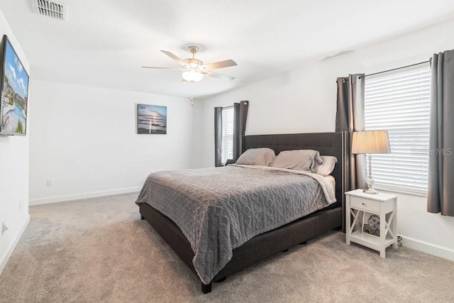 bedroom with light carpet and ceiling fan