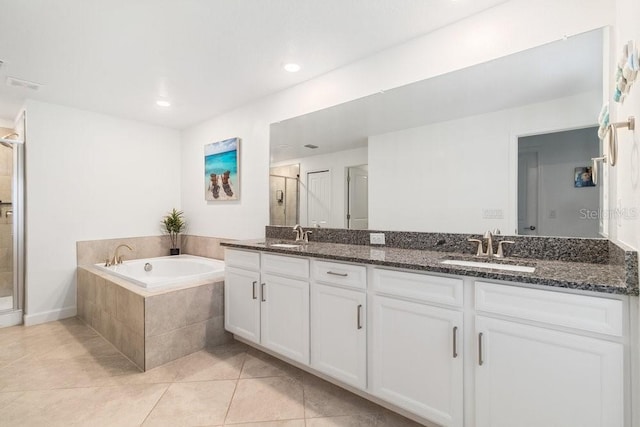 bathroom with independent shower and bath, vanity, and tile patterned floors