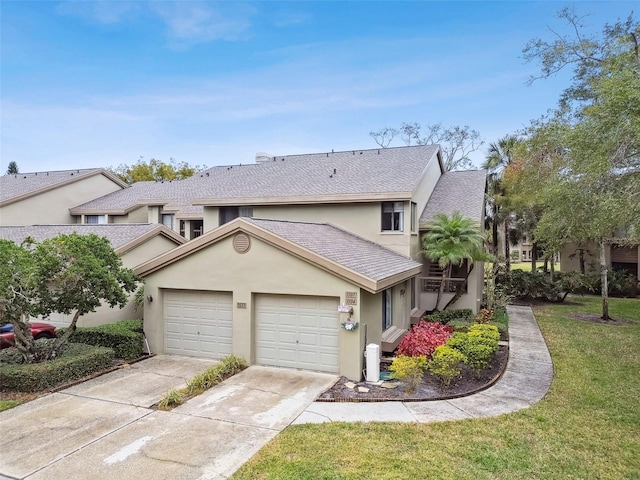 view of front facade featuring a garage and a front lawn