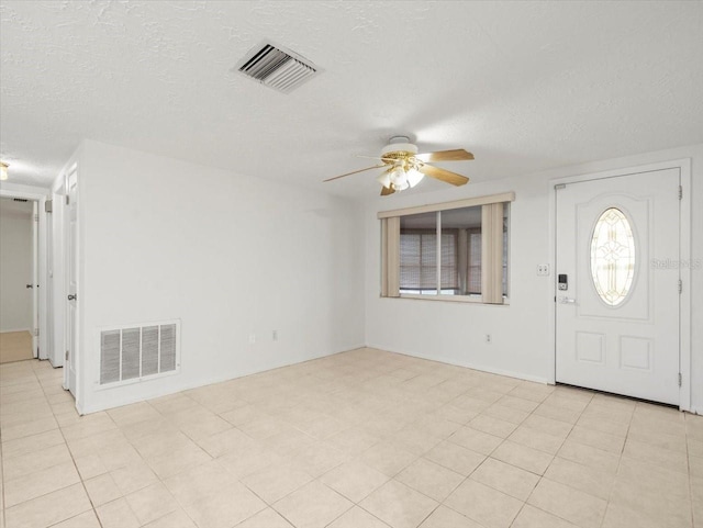 entryway featuring a textured ceiling and ceiling fan