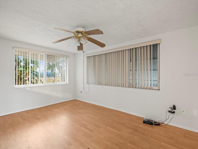 spare room featuring ceiling fan, a textured ceiling, and light wood-type flooring