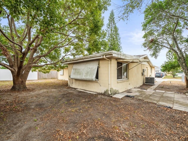 view of side of property featuring central AC