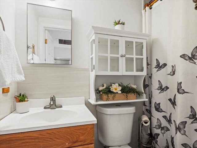 bathroom featuring vanity and toilet