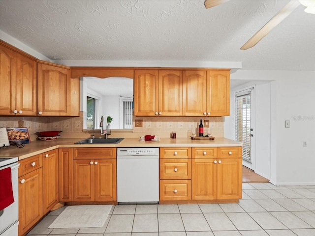 kitchen featuring white appliances, light tile patterned floors, sink, and backsplash