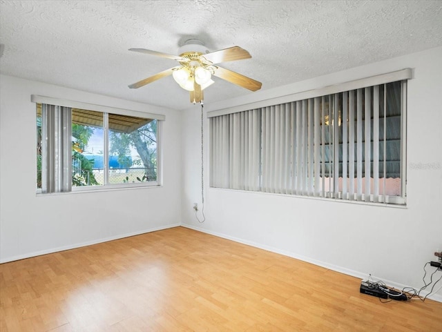 unfurnished room featuring a textured ceiling, wood-type flooring, and ceiling fan