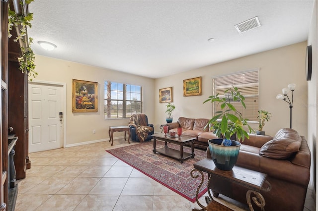 living room featuring light tile patterned floors and a textured ceiling