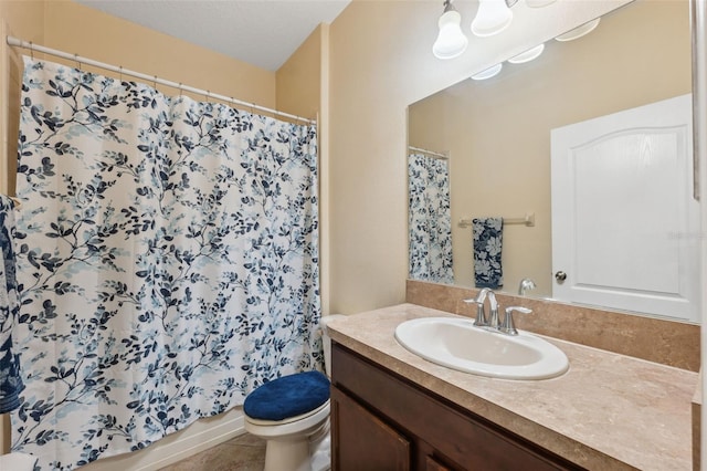 bathroom with vanity, tile patterned floors, and toilet