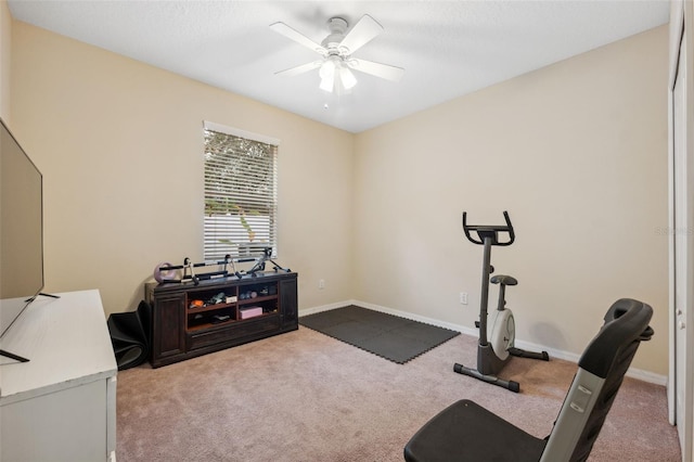 workout area with ceiling fan and light carpet