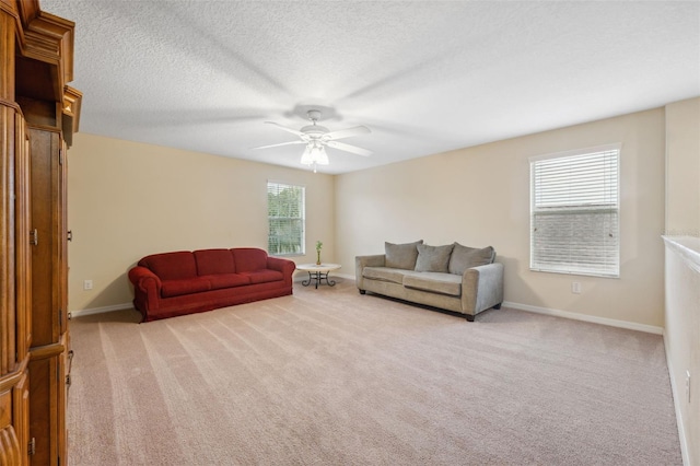 carpeted living room featuring ceiling fan