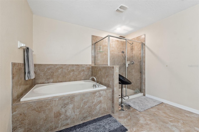 bathroom with shower with separate bathtub, tile patterned flooring, and a textured ceiling