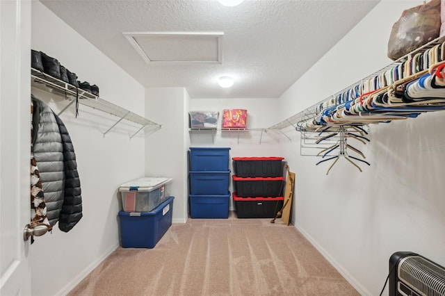 spacious closet featuring carpet and heating unit