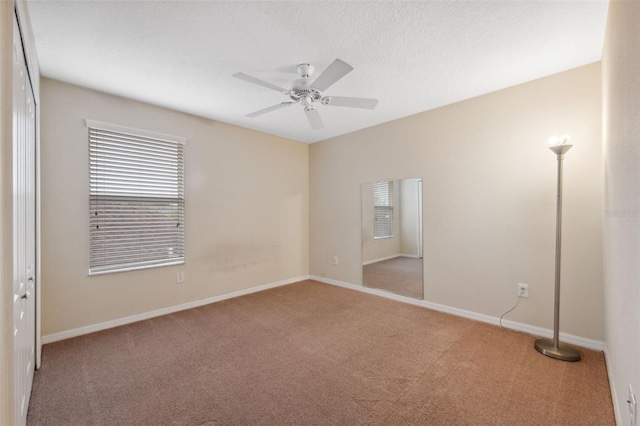 unfurnished room featuring carpet floors and ceiling fan