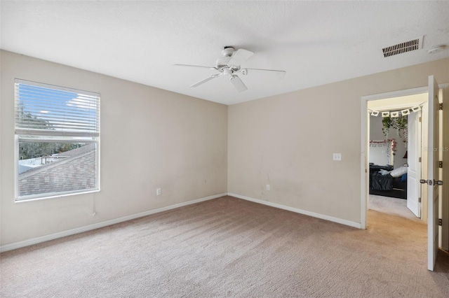 unfurnished room featuring ceiling fan and light colored carpet