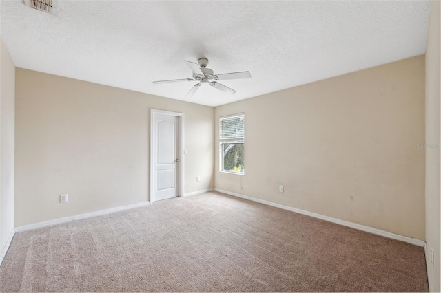 unfurnished room with ceiling fan, light colored carpet, and a textured ceiling