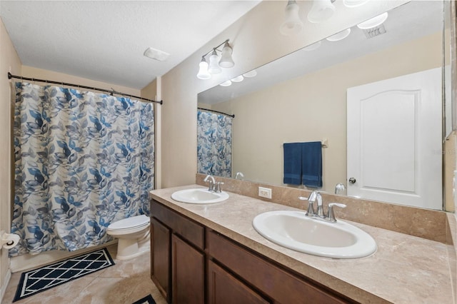 bathroom with tile patterned flooring, vanity, a textured ceiling, curtained shower, and toilet