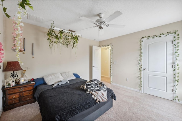 carpeted bedroom featuring a textured ceiling and ceiling fan