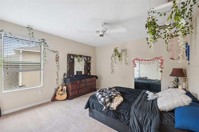 bedroom with ceiling fan, carpet, and multiple windows