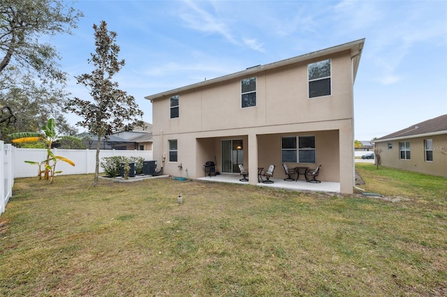 back of property with a lawn, a patio area, and central air condition unit