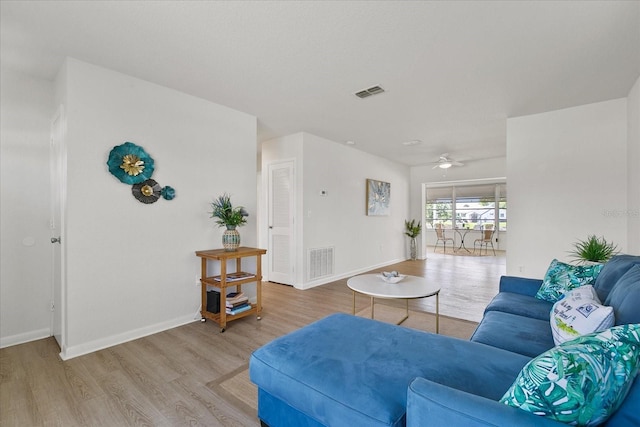 living room featuring hardwood / wood-style floors and ceiling fan