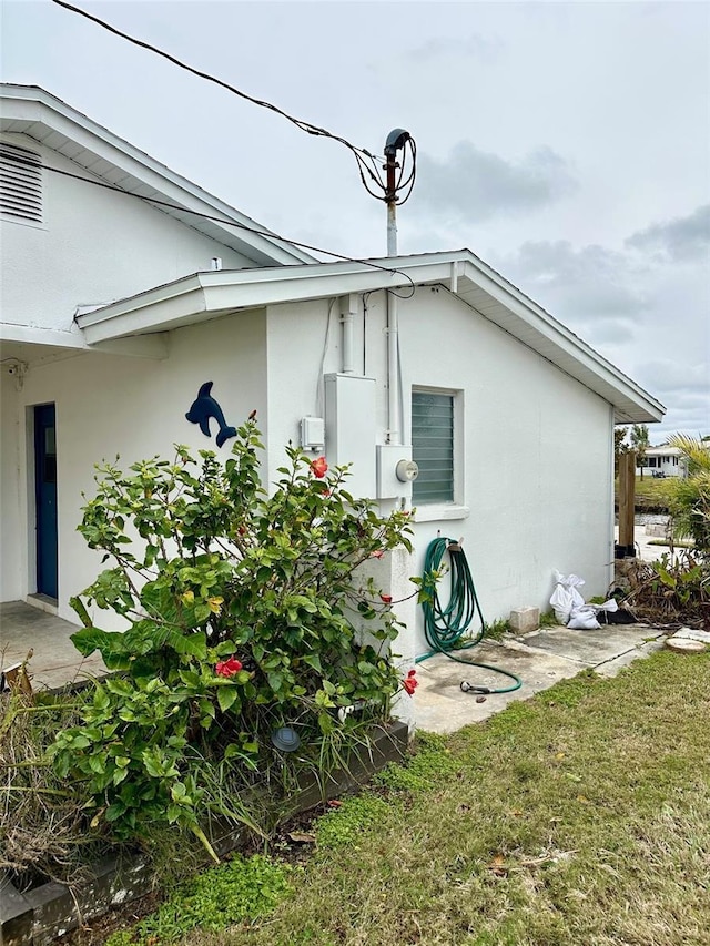 view of side of home with a lawn