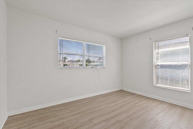 unfurnished room with light wood-type flooring