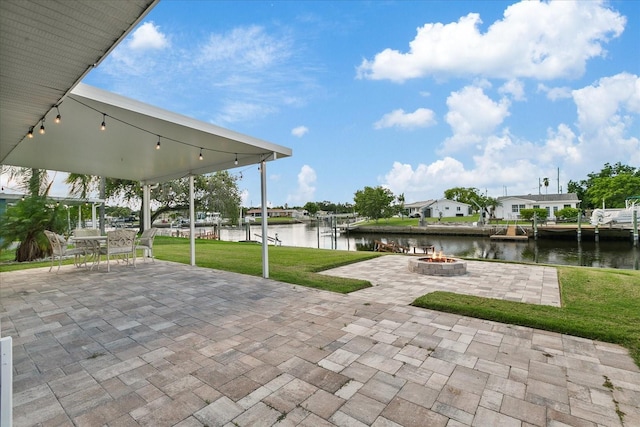 view of patio / terrace with a water view, an outdoor fire pit, and a boat dock