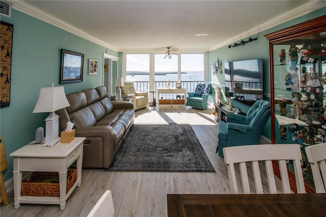 living room featuring crown molding, ceiling fan, expansive windows, and light hardwood / wood-style floors