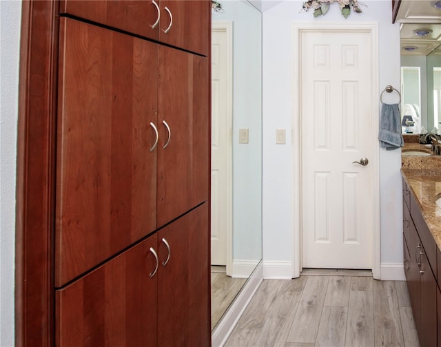 interior space featuring vanity and hardwood / wood-style floors