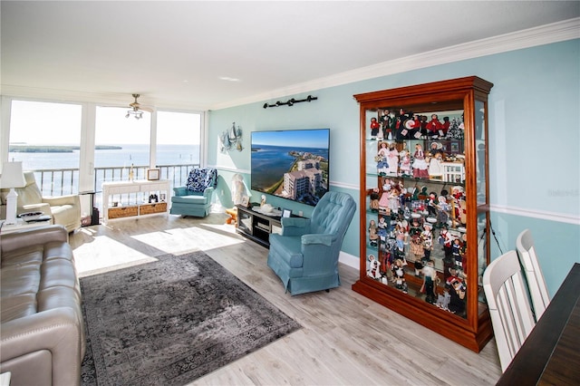 living room with light hardwood / wood-style flooring and ornamental molding