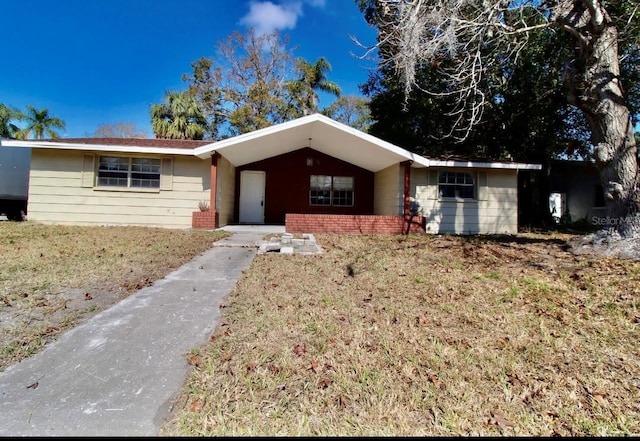 ranch-style home with a front lawn