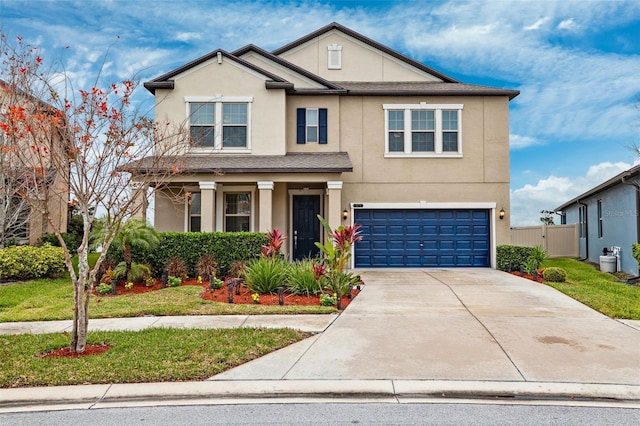 view of front facade with a garage and a front lawn