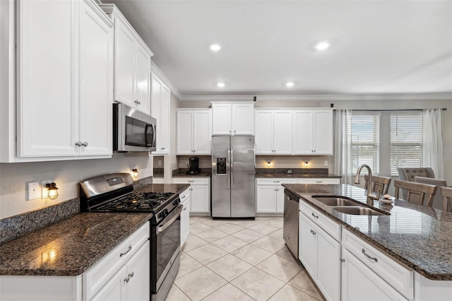 kitchen featuring white cabinetry, an island with sink, stainless steel appliances, and sink